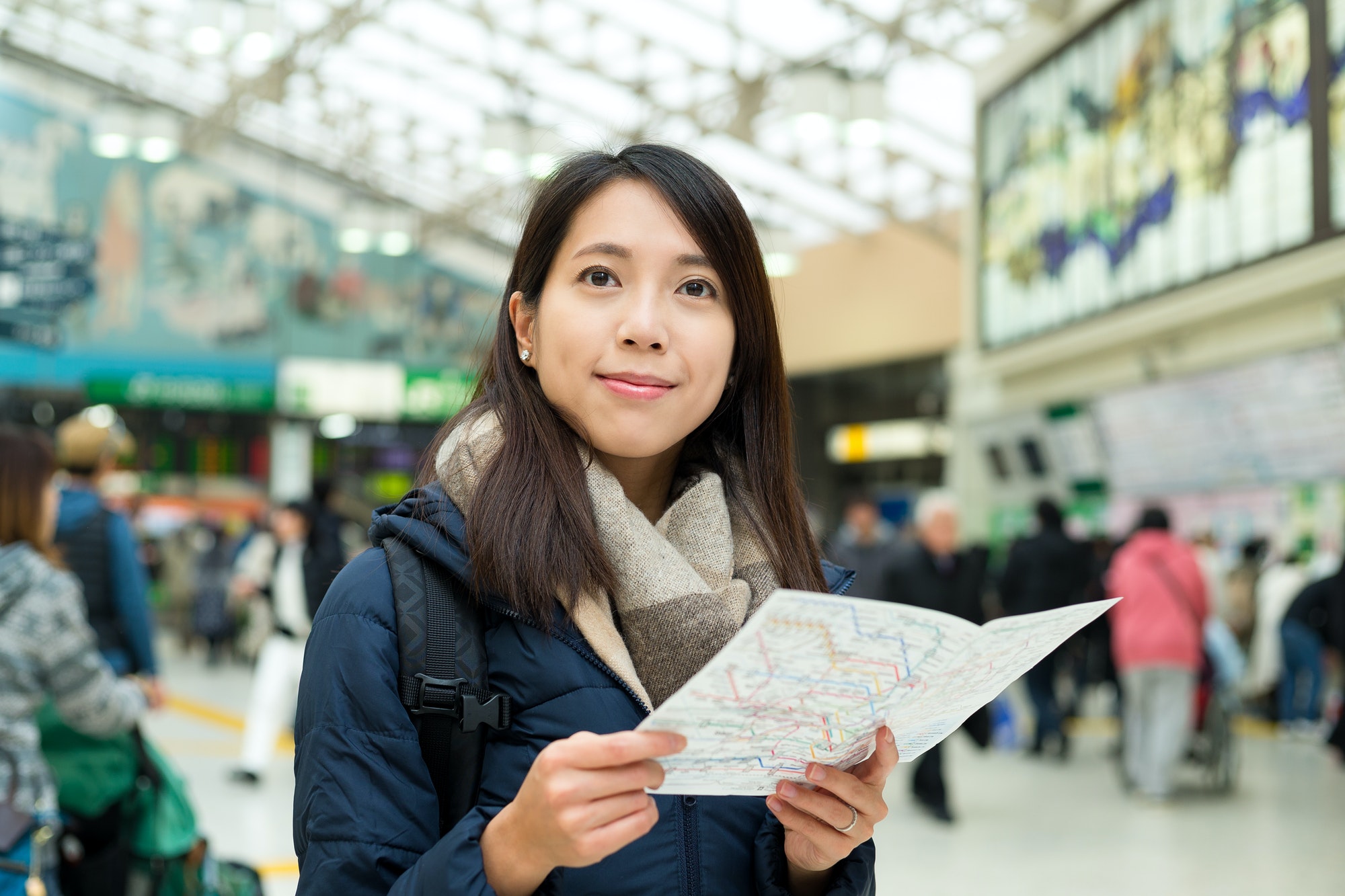 Woman using map inside train station